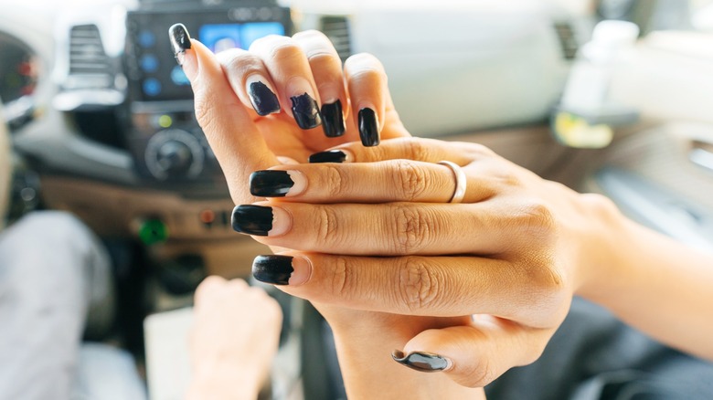 A person with chipped nail polish
