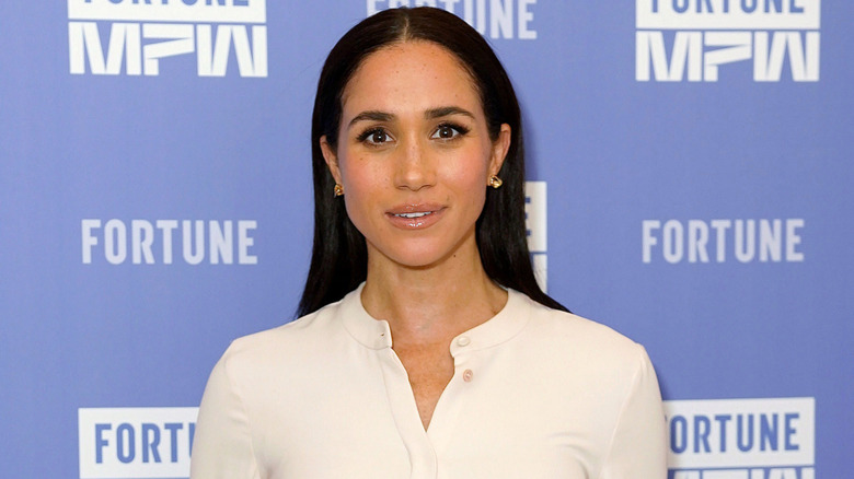 Meghan Markle wearing a white top