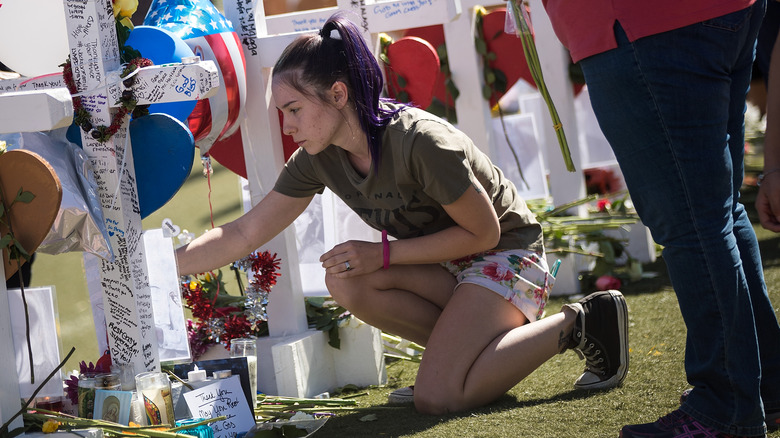 Woman grieves at cemetery