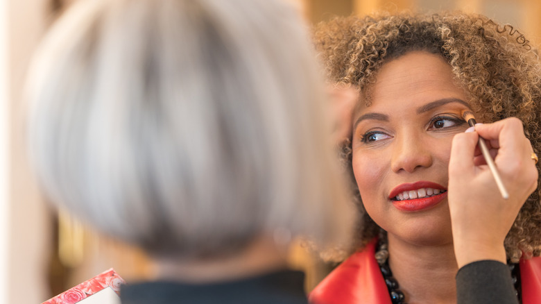 Woman getting makeup done