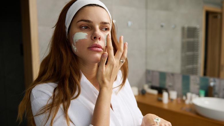 Woman exfoliating face