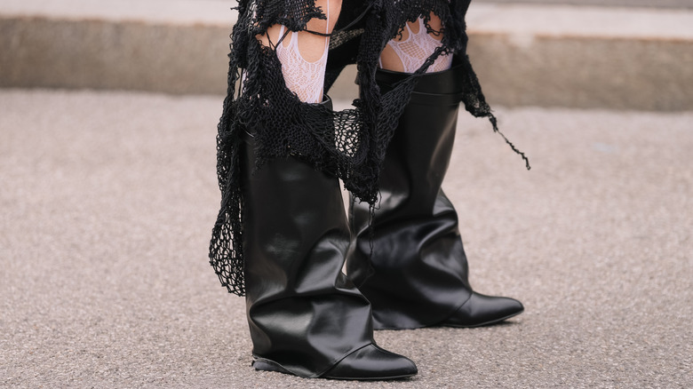 A pair of slouchy black leather boots from a woman in the street