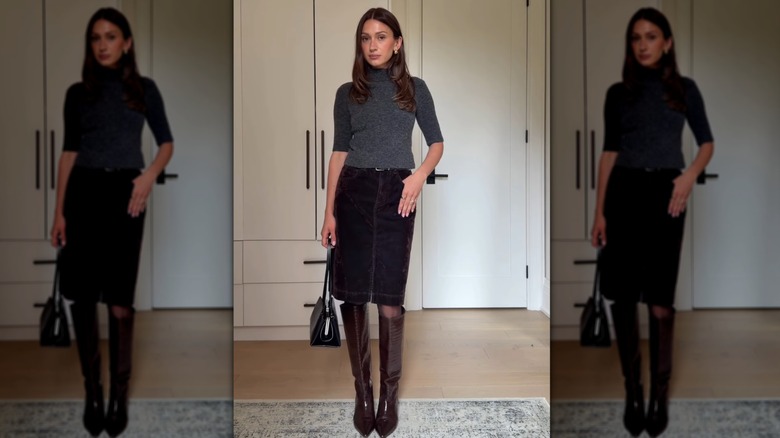 A straight-on view of a woman wearing a knee-length skirt and boots
