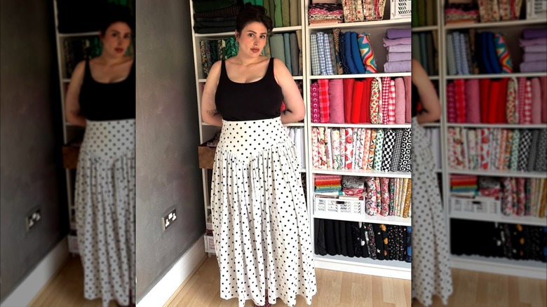 A woman in a polkadot skirt and black tank top
