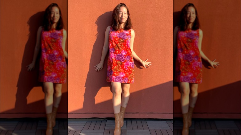 A woman in a red and purple print shift dress