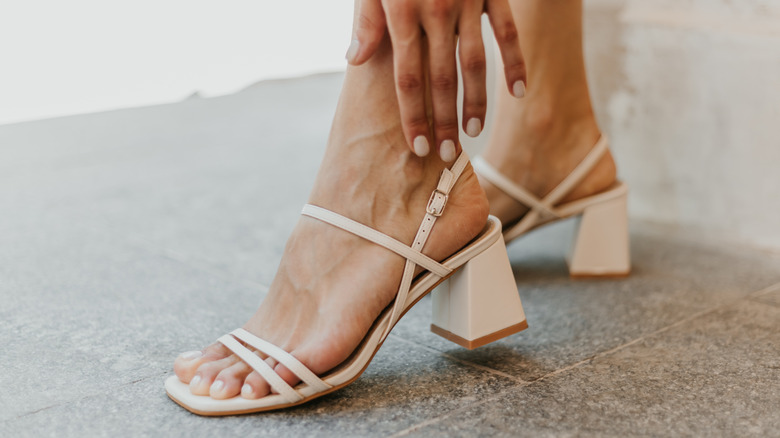 Woman wearing nude block heels with nude straps