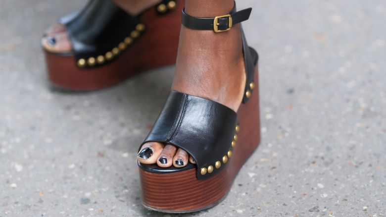 Woman wearing nude wedge mules
