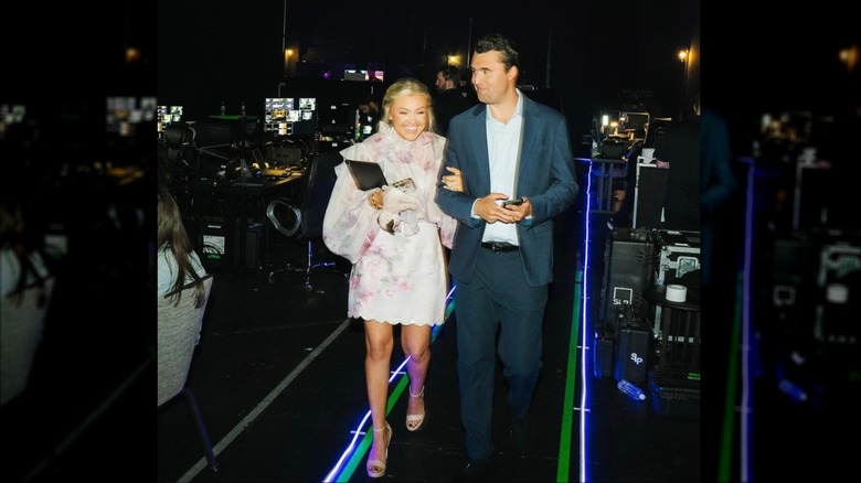 Erika and Charlie Kirk arm in arm at an event