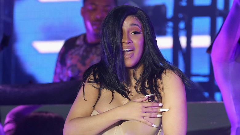 Cardi B covering her chest