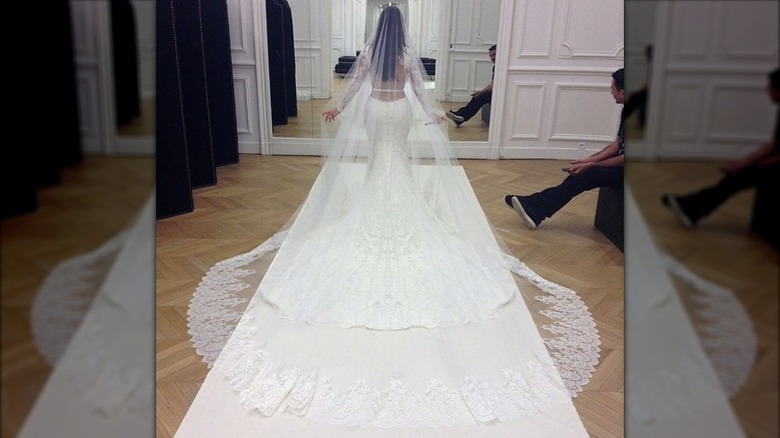 The back of Kim Kardashian posing in her wedding dress