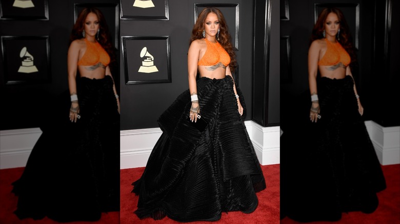 Rihanna in a black skirt and orange top at the 2017 Grammys