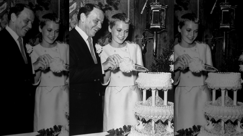 Frank Sinatra and Mia Farrow cutting a wedding cake