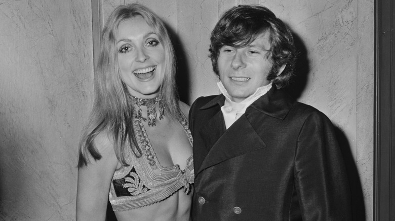 Sharon Tate smiling next to Roman Polanski