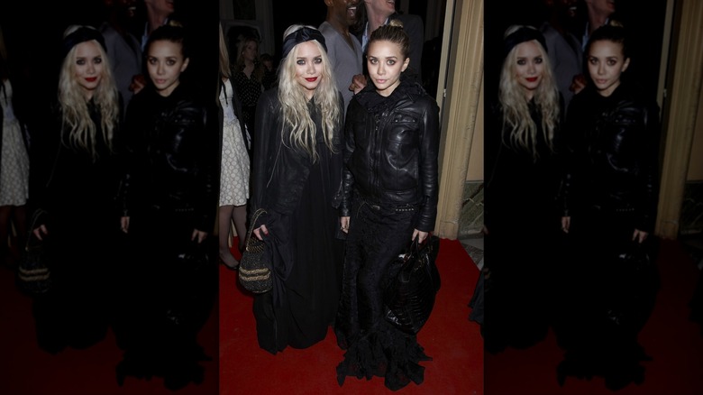 Mary-Kate (L) and Ashley Olsen (R) pose wearing matching leather jackets