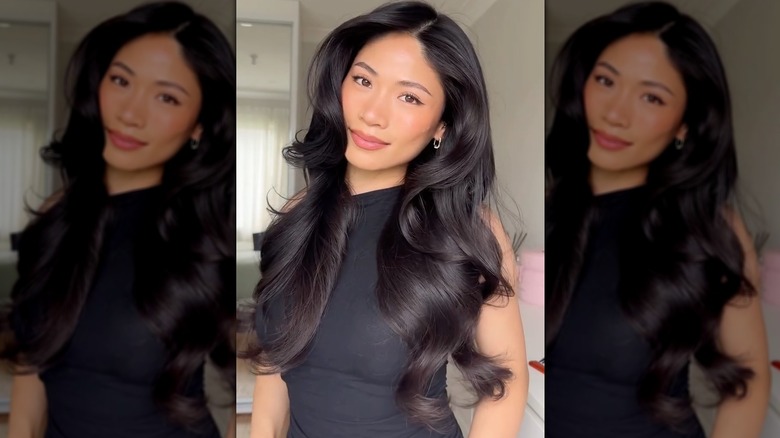 A woman with dark hair in a voluminous blowout