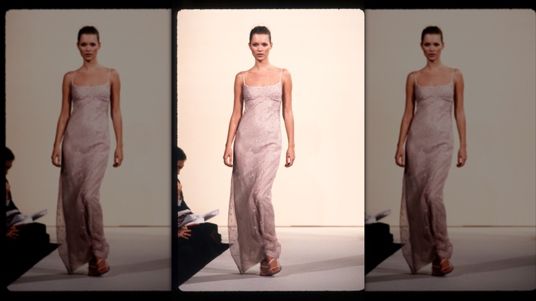 Kate Moss wearing a blush slip dress on the runway.