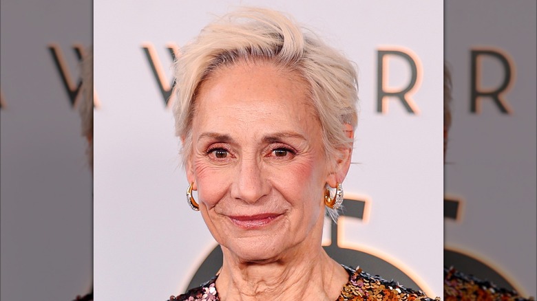 Laurie Metcalf smiling while showing her gray bob on the 2026 Tonys red carpet