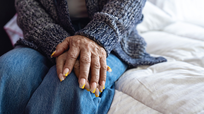 Older woman with painted nails