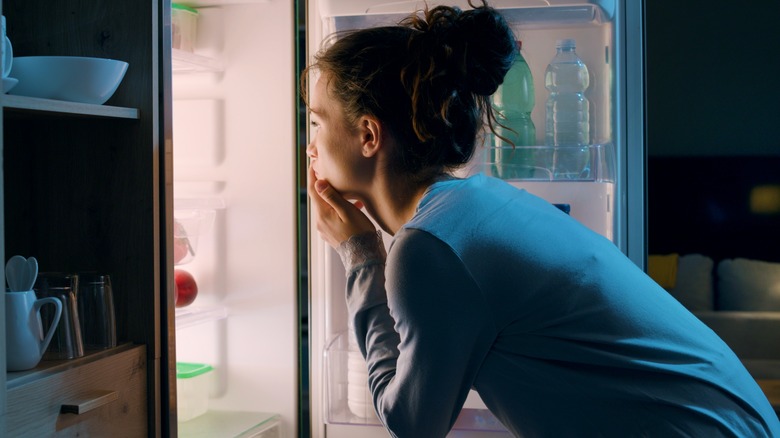 Woman looking into fridge