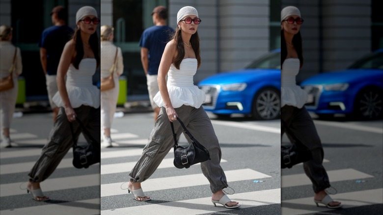 Woman wearing a white top and baggy pants