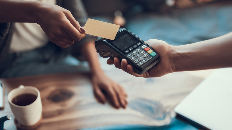 Woman paying at coffee shop
