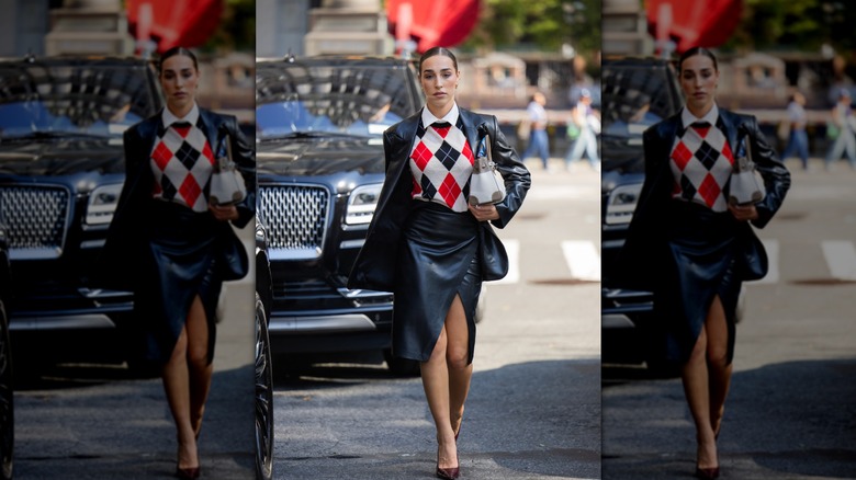 Ginevra Mavilla wearing argyle sweater, black leather blazer and skirt, Hermes bag outside Alice & Olivia during New York Fashion Week on September 13, 2025