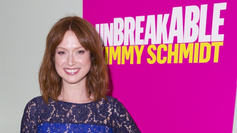 Ellie Kemper posing next to an Unbreakable Kimmy Schmidt sign