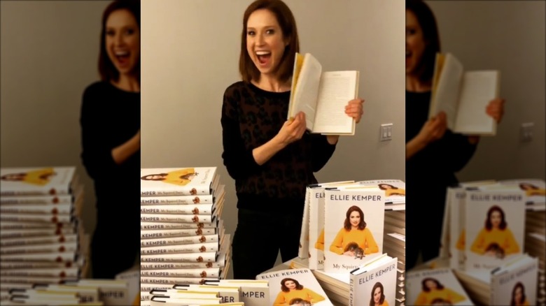 Ellie Kemper posing with her book
