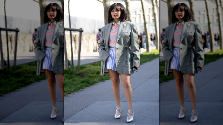 Woman wearing oversized gray jacket