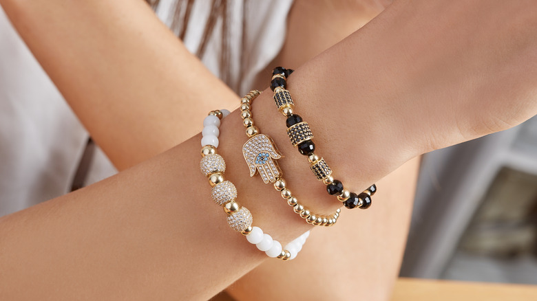 three bracelets on woman's arm 
