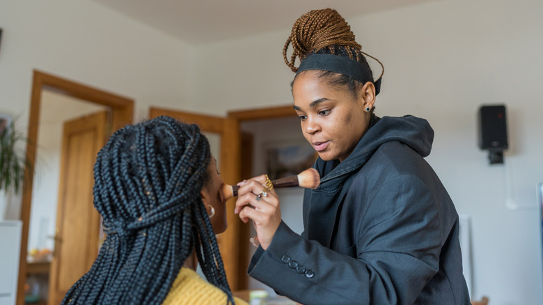 Makeup artist applying foundation