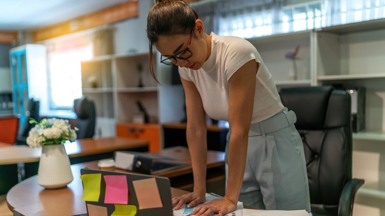 Woman standing at her desk