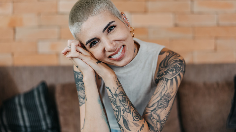 smiling woman with tattoos