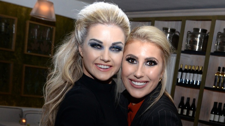 Lindsay Arnold and Emma Slater hugging and smiling for a photo together