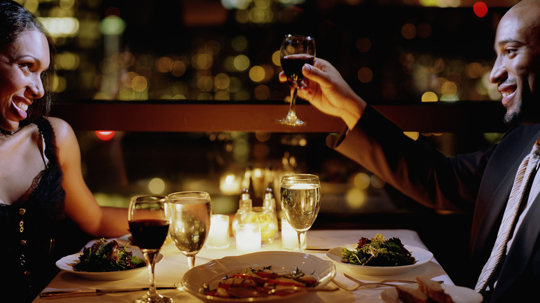 A couple toasting at dinner