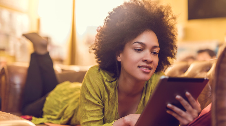 woman reading on tablet