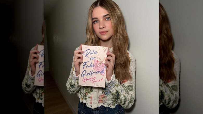 Raegan Revord with their book Rule for Fake Girlfriends