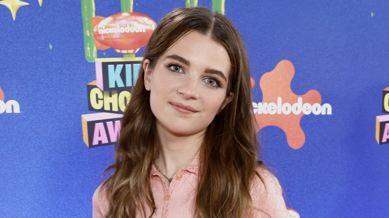 Raegan Revord wearing peach shirt at Kids Choice Awards