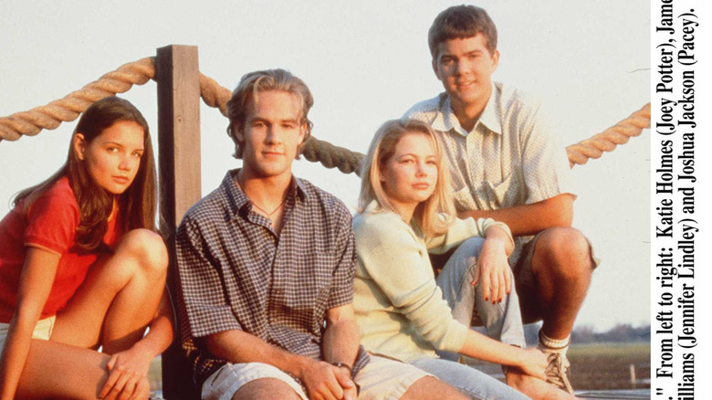 The cast of "Dawson's Creek" sitting on a pier