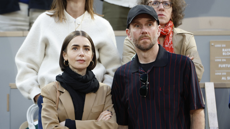 Lily Collins and husband Charlie McDowell attend the men's final on day 15 of the 2025 French Open, Roland-Garros 2025