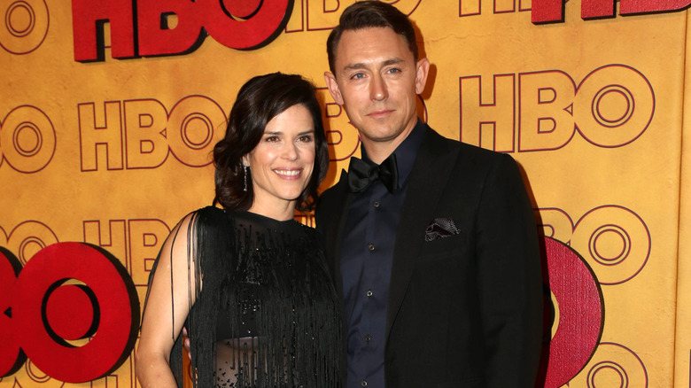 Neve Campbell and JJ Feild wearing black