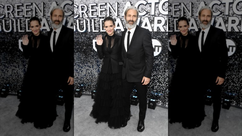 Winona Ryder and boyfriend Scott Mackinley Hahn on the red carpet wearing all black
