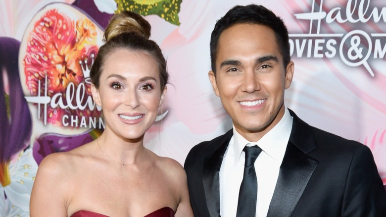 Alexa PenaVega posing with Carlos PenaVega on the red carpet