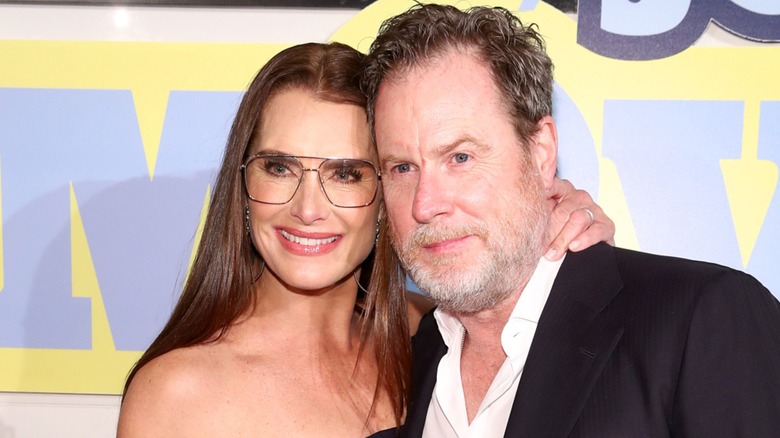 Brooke Shields posing on the red carpet with Chris Henchy
