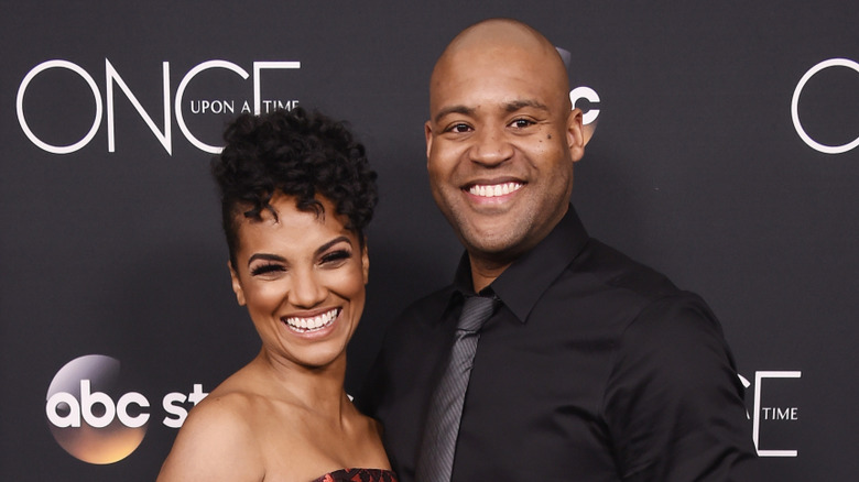Mekia Cox and Britt Leach smiling together at an ABC red carpet event