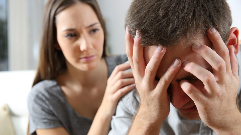 Woman comforting man