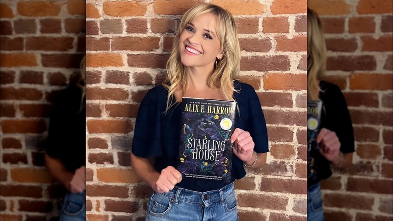 Reese Witherspoon holding a copy of Starling House