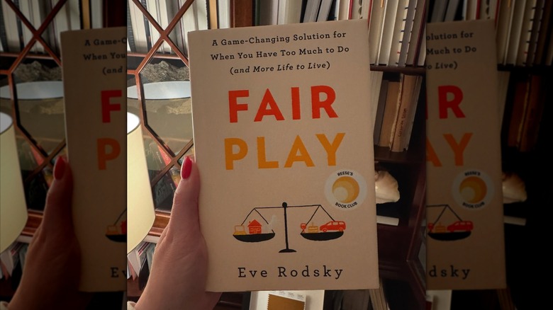 A person holding air Play: A Game Changing Solution When You Have Too Much To Do (And More Life to Live), by Eve Rodsky