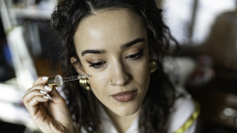 Woman applying serum