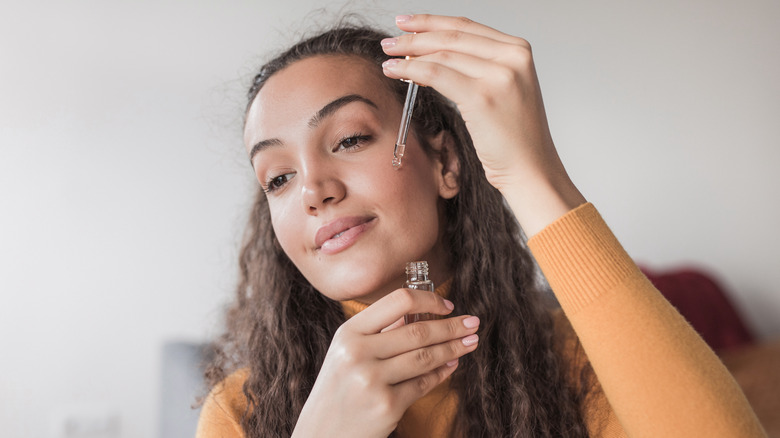 Woman applying skincare